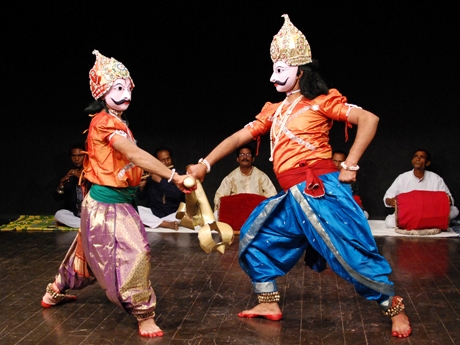two performers in traditional Diwali masks