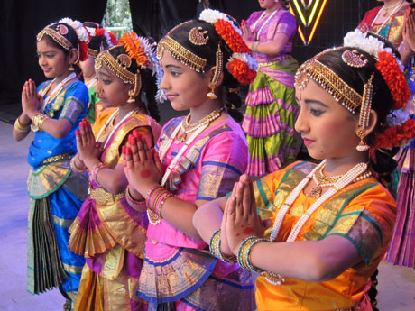 four girls celebrating Diwali together on stage